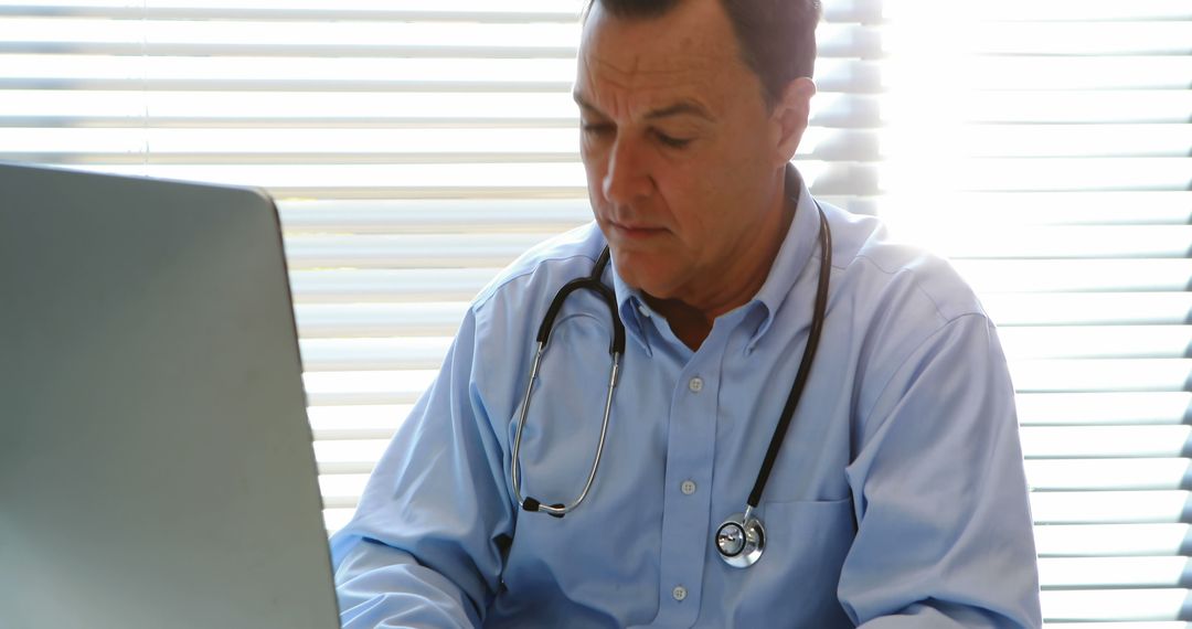 Doctor Using Laptop in Office during Daytime - Free Images, Stock Photos and Pictures on Pikwizard.com