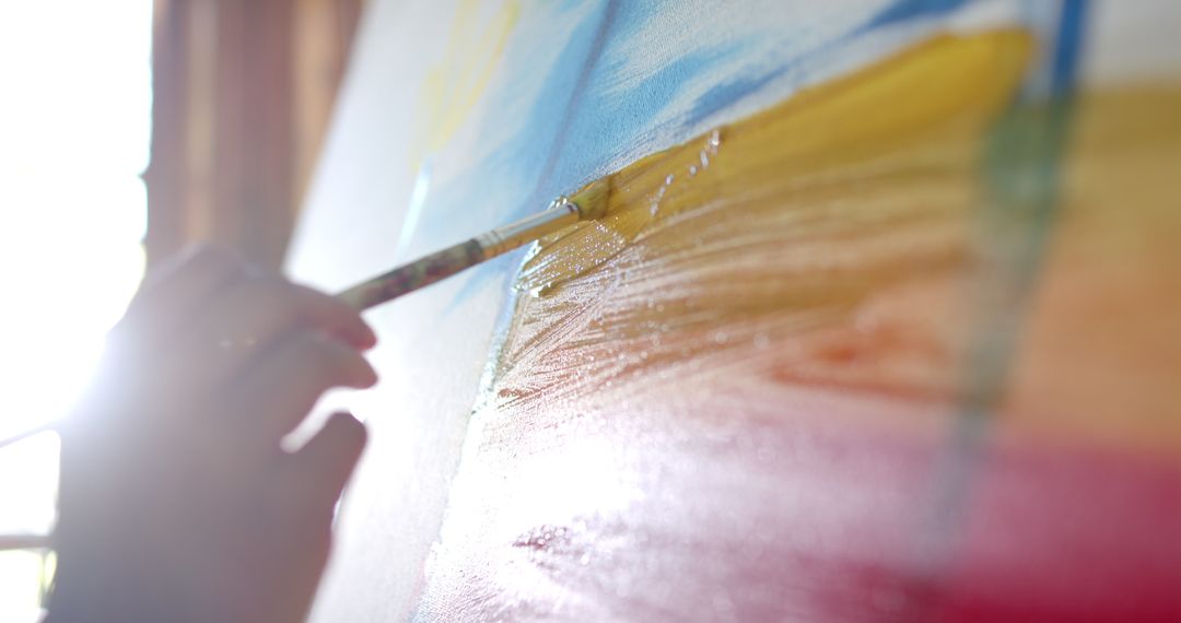 Close Up of Senior Art Enthusiast Painting Canvas at Home