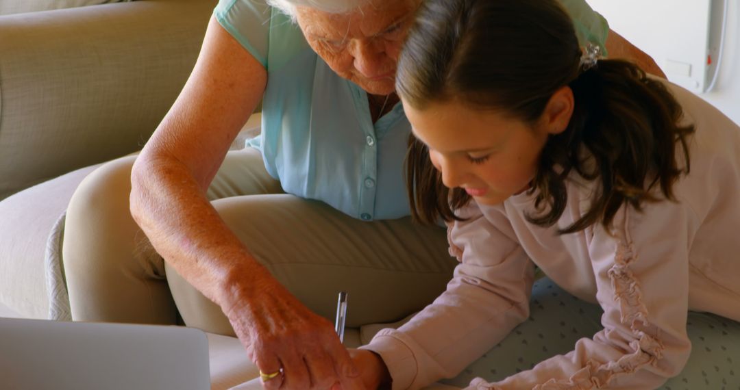 Grandmother Helping Granddaughter with Homework at Home - Free Images, Stock Photos and Pictures on Pikwizard.com