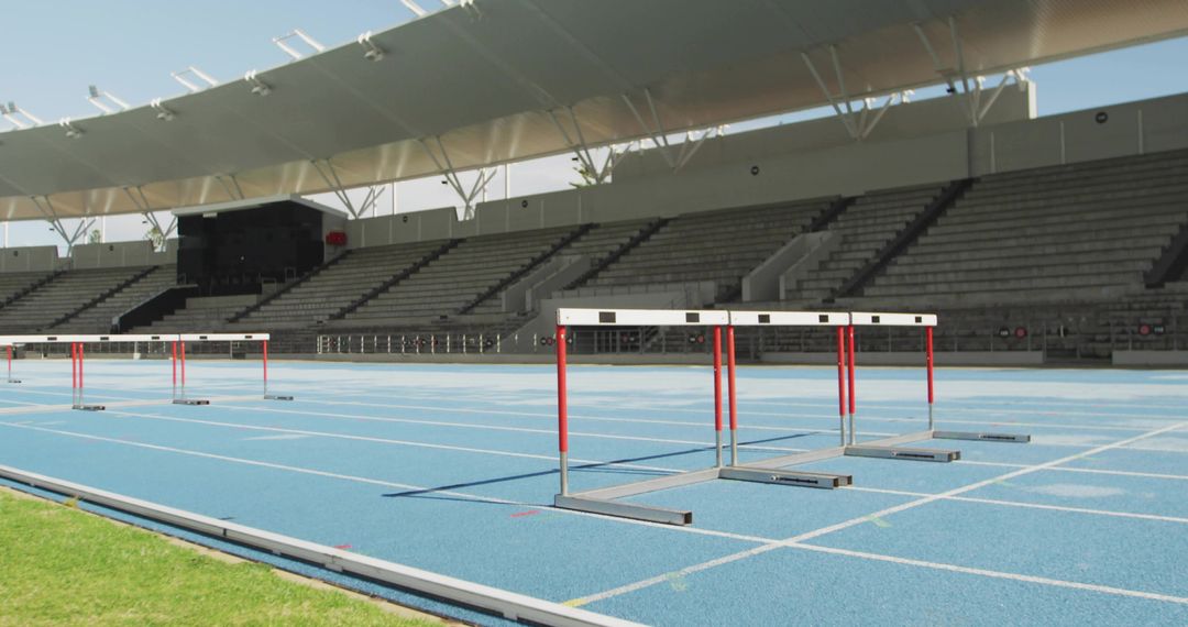 Featuring Red-and-White Hurdles on Blue Track in Empty Stadium for Athletics Training