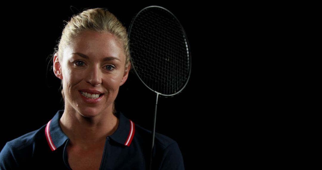 Female Badminton Player Posing with Racket Against Black Background - Free Images, Stock Photos and Pictures on Pikwizard.com