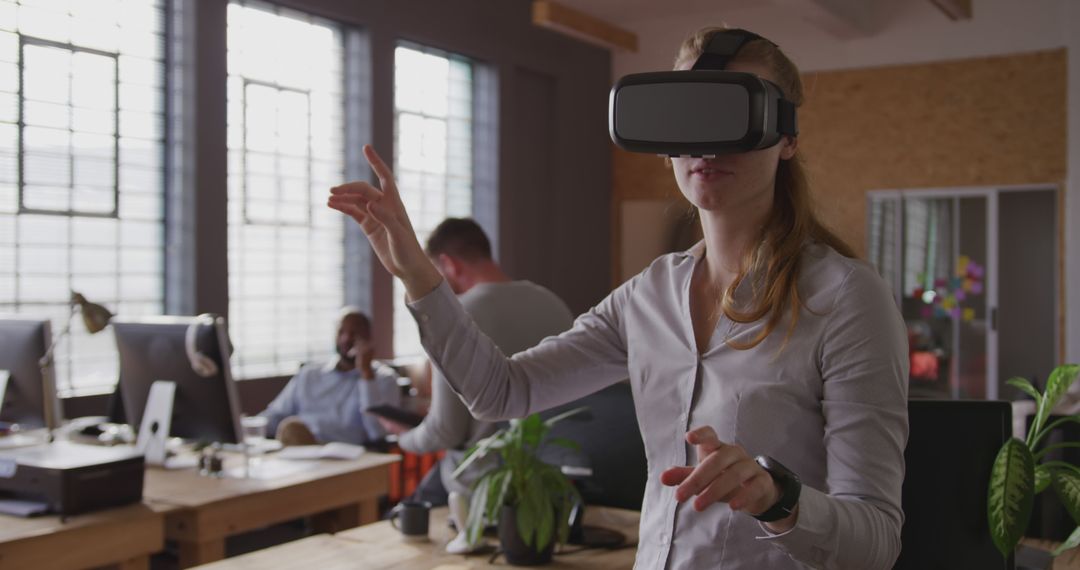 Woman Using Virtual Reality Headset in Modern Office - Free Images, Stock Photos and Pictures on Pikwizard.com