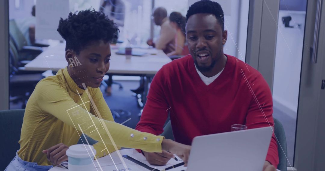 Colleagues Collaborating over Laptop in Modern Office Environment