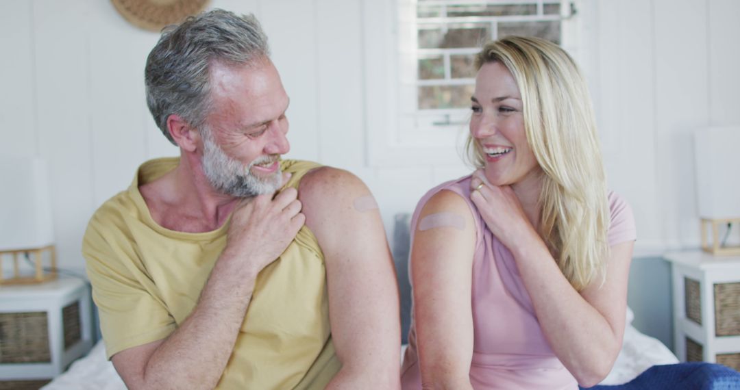 Happy Couple Showing Vaccination Bandages at Home