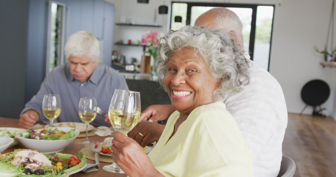 Senior Friends Enjoying Dinner Gathering with Wine