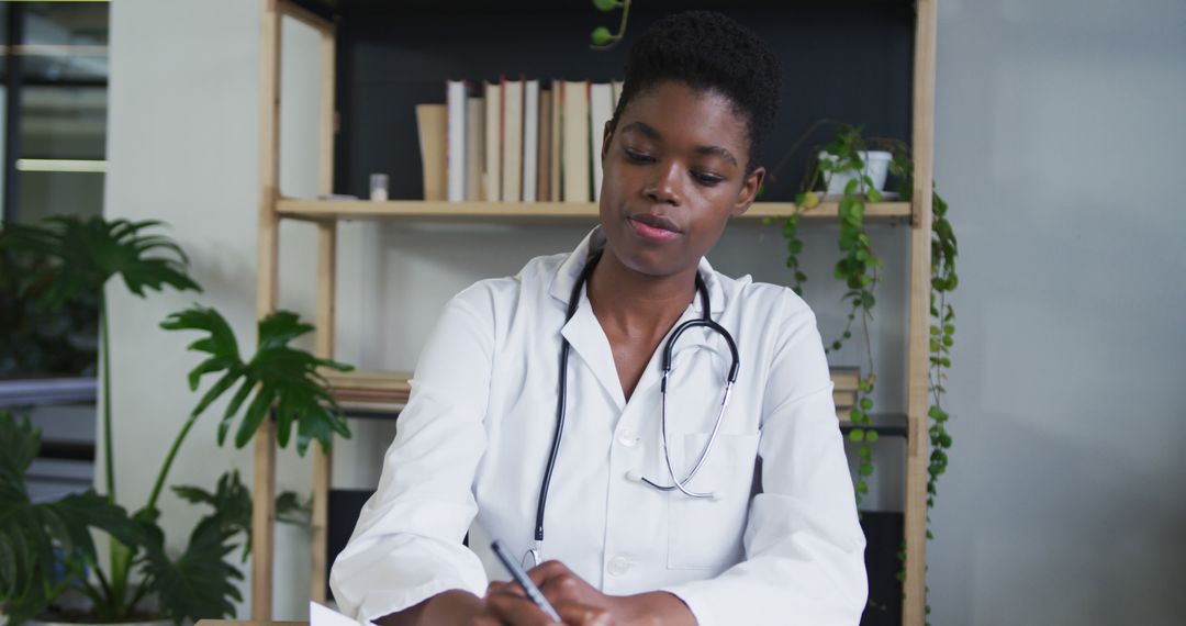 Focused Female Doctor Writing Notes in Modern Office - Free Images, Stock Photos and Pictures on Pikwizard.com