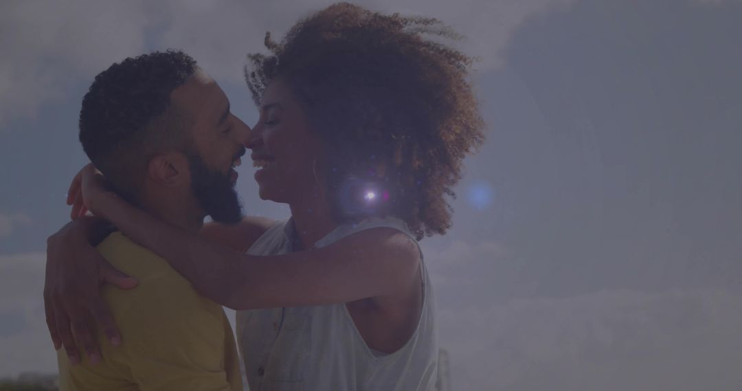 Joyful Embrace of Young Couple Glowing in Sunlight