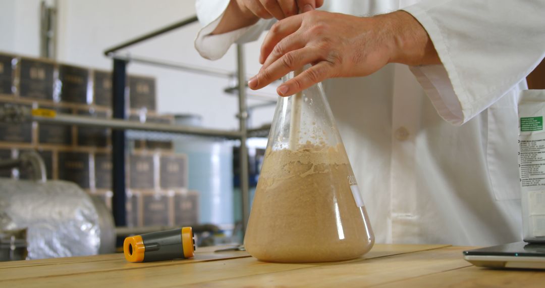 Scientist Mixing Substance in Flask in Laboratory - Free Images, Stock Photos and Pictures on Pikwizard.com