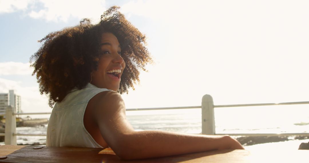 Joyful Woman Enjoying Coastal Sunshine Moments Near Sea