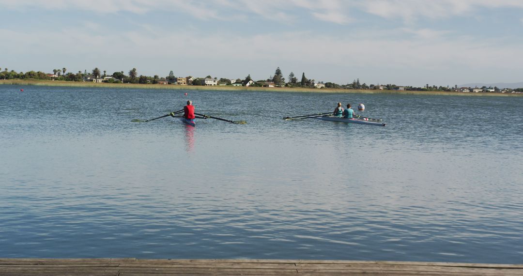 Two Rowers Practicing on Calm Lake Under Blue Sky - Free Images, Stock Photos and Pictures on Pikwizard.com