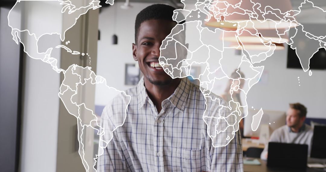 Smiling African American Man in Office with World Map Overlay - Free Images, Stock Photos and Pictures on Pikwizard.com