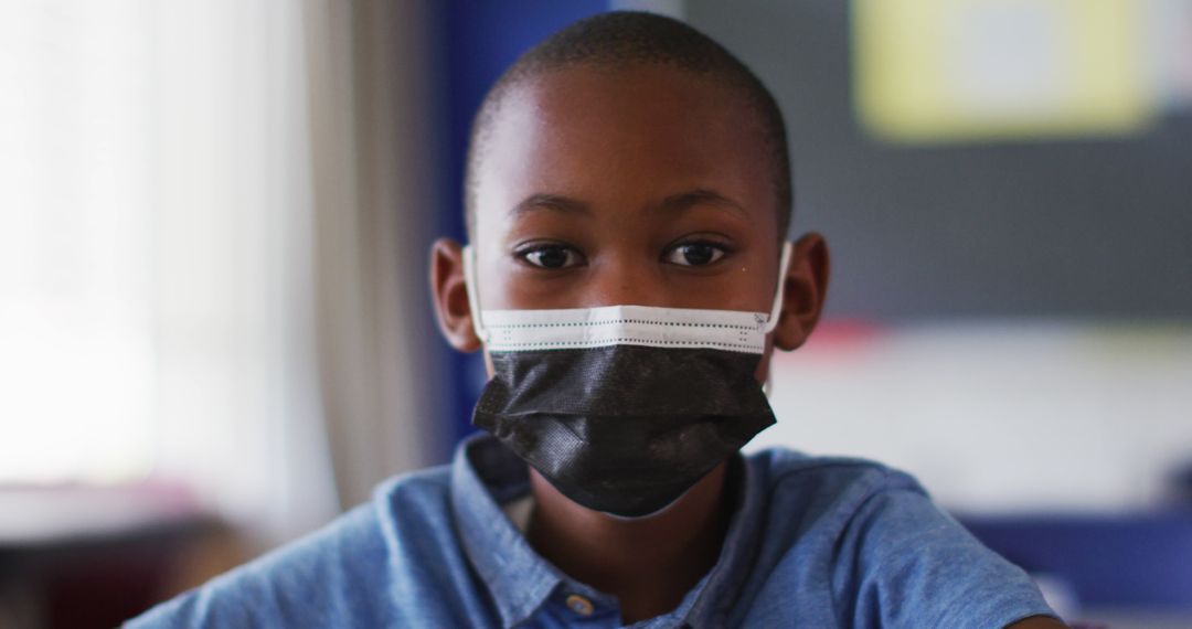 Indoor Portrait of African American Boy Wearing Black Face Mask and Blue Shirt - Free Images, Stock Photos and Pictures on Pikwizard.com