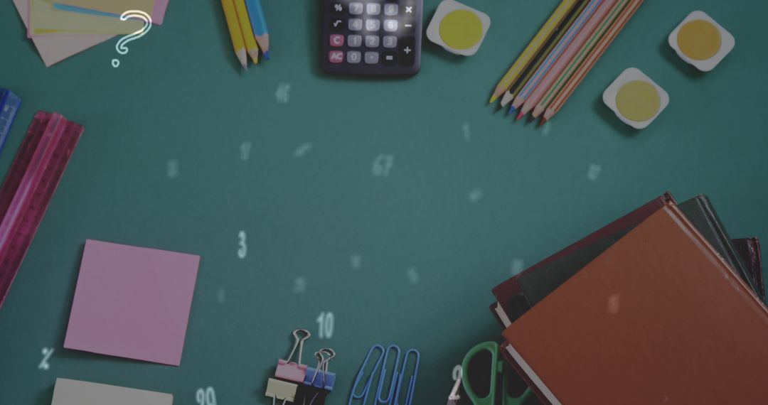 Assorted School Supplies on Green Table for Classroom Creativity