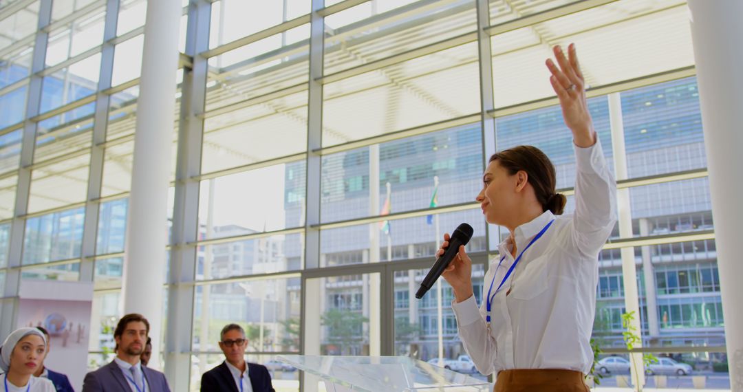 Businesswoman Speaking at Conference in Modern Office Building - Free Images, Stock Photos and Pictures on Pikwizard.com