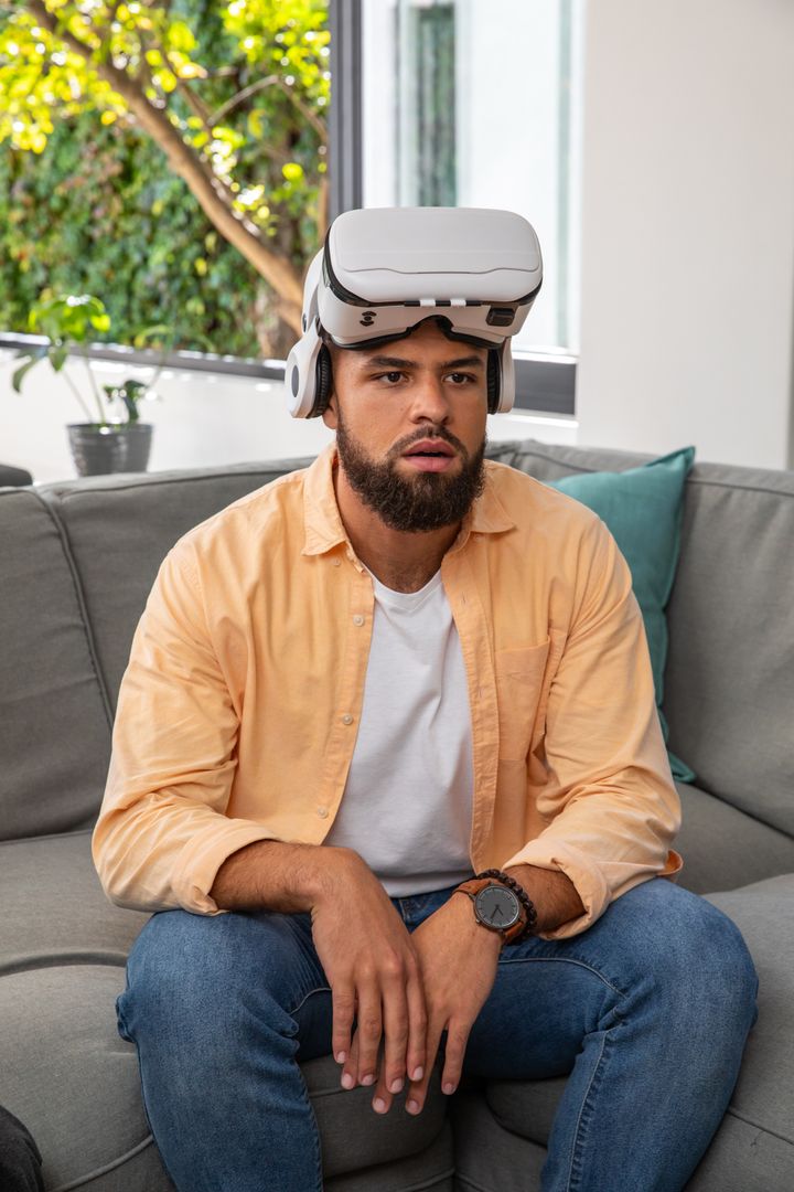 Man Using Virtual Reality Headset in Modern Living Room