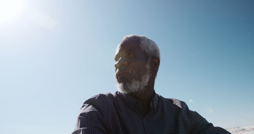 Contemplative Elderly Man Under Clear Blue Sky - Free Images, Stock Photos and Pictures on Pikwizard.com