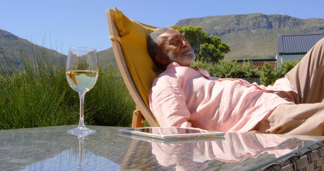 Man Relaxing Outdoors on Lounge Chair with Wine Glass - Free Images, Stock Photos and Pictures on Pikwizard.com