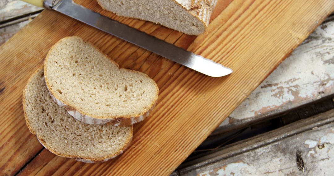 Rustic Sliced Bread with Knife on Wooden Board - Free Images, Stock Photos and Pictures on Pikwizard.com