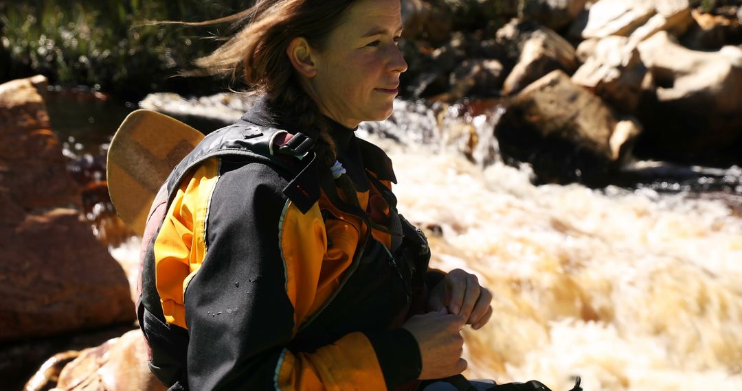 Female Kayaker Preparing for Whitewater Adventure in Rocky River - Free Images, Stock Photos and Pictures on Pikwizard.com