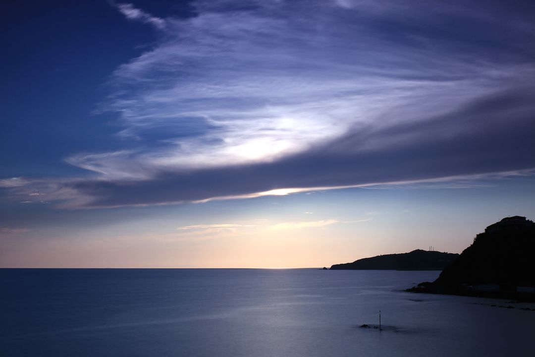 Tranquil Twilight Over Calm Sea with Mountains - Free Images, Stock Photos and Pictures on Pikwizard.com