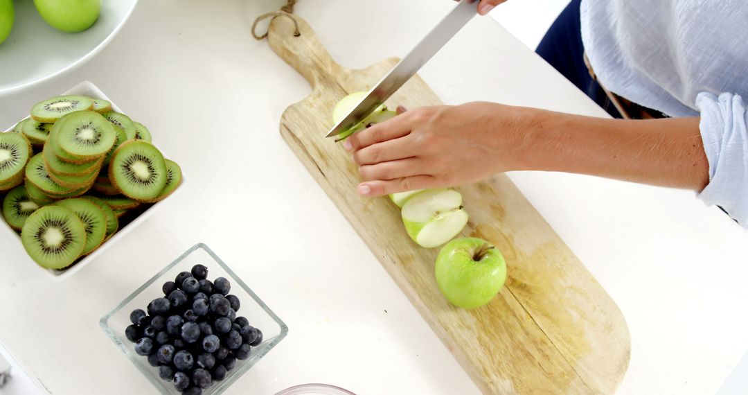 Hands Preparing Fresh Fruit for a Healthy Snack