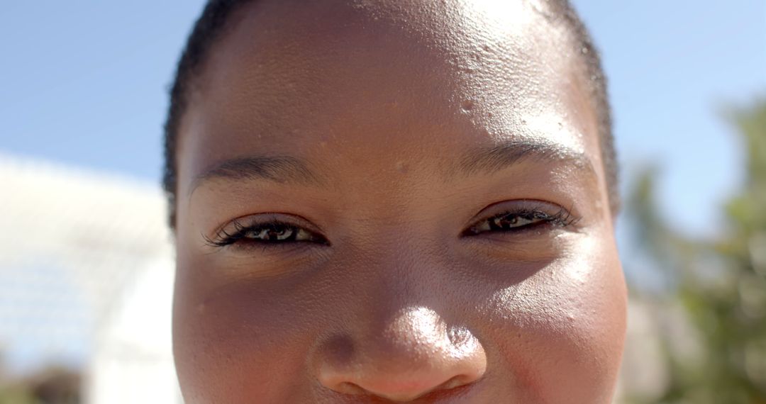 Close-Up Portrait of Smiling African American Woman Outdoors on a Sunny Day - Free Images, Stock Photos and Pictures on Pikwizard.com