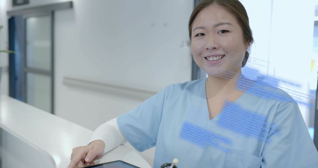 Smiling Korean Nurse Using Tablet at Hospital Reception for Patient Care and EHR Access