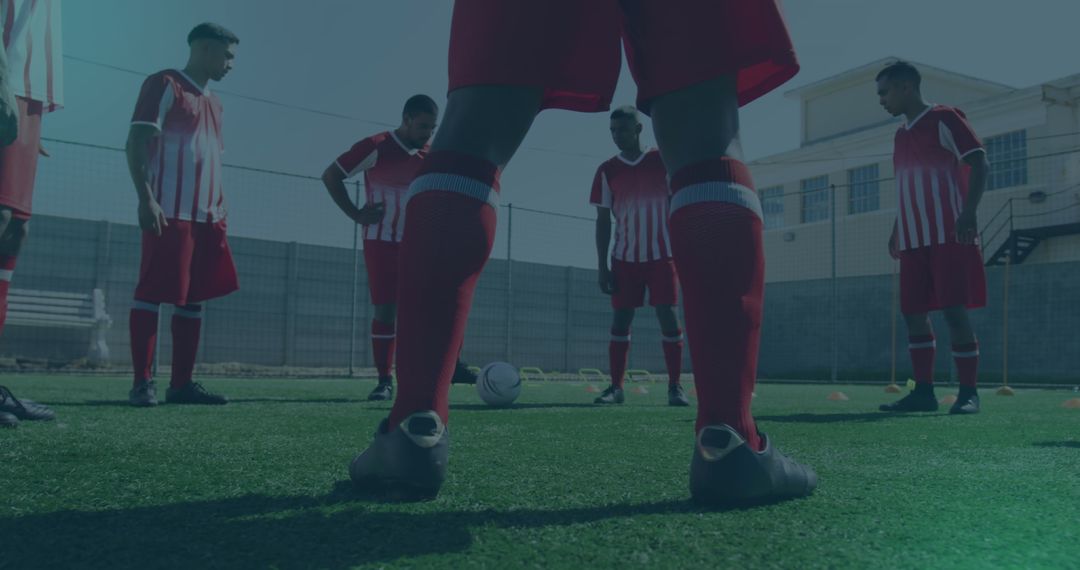 Soccer Team strategizing before practice in matching uniforms
