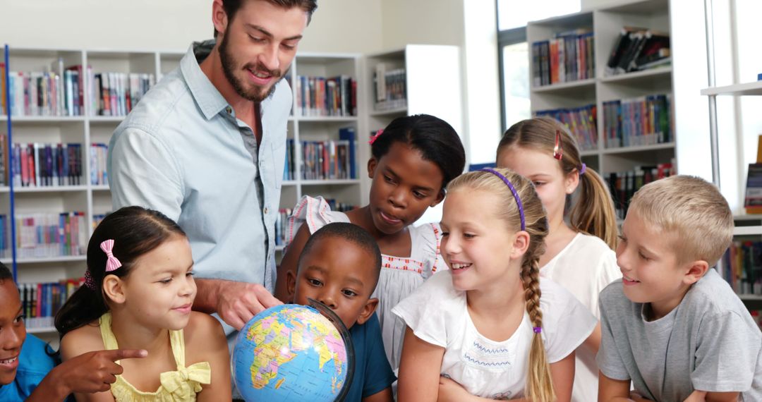 Teacher Showing Diverse Children Globe in Library Classroom - Free Images, Stock Photos and Pictures on Pikwizard.com