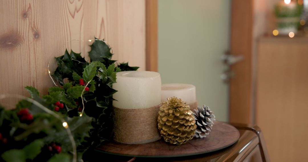 Festive Christmas Decor with Candles and Holly on Rustic Table