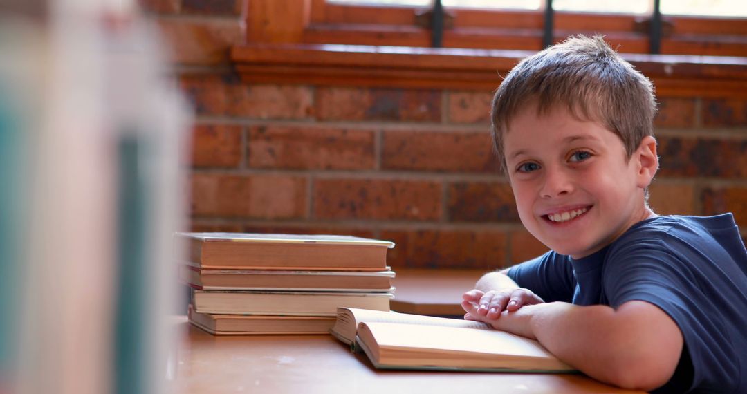 Smiling Young Boy Reading Book in Cozy Room - Free Images, Stock Photos and Pictures on Pikwizard.com