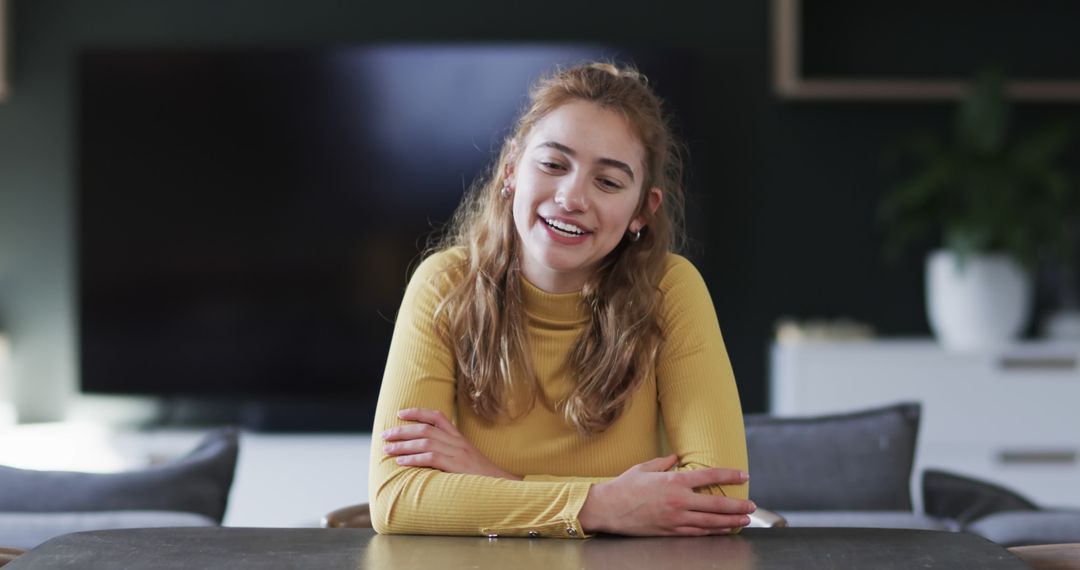 Young Woman Laughing in Modern Living Room, Relaxed Atmosphere - Free Images, Stock Photos and Pictures on Pikwizard.com