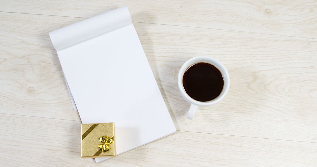 Blank Notepad with Coffee Cup and Gift Box on Wooden Desk - Free Images, Stock Photos and Pictures on Pikwizard.com