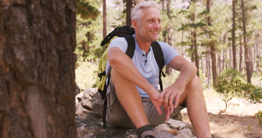 Happy Mature Hiker Taking Break in Serene Forest Wilderness