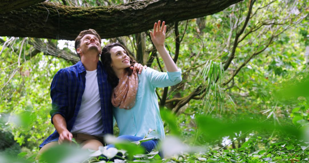 Young Couple Enjoying Nature Walk in Lush Forest