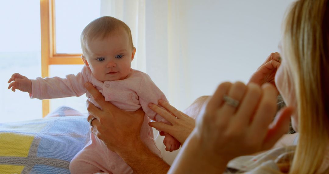 Mother Holding Baby in Sunlit Room - Free Images, Stock Photos and Pictures on Pikwizard.com