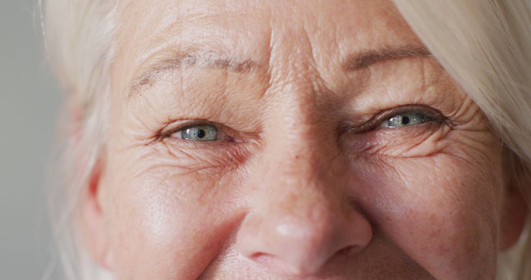 Close-up of Elderly Woman's Face Highlighting Wrinkles and Smiling Eyes - Free Images, Stock Photos and Pictures on Pikwizard.com