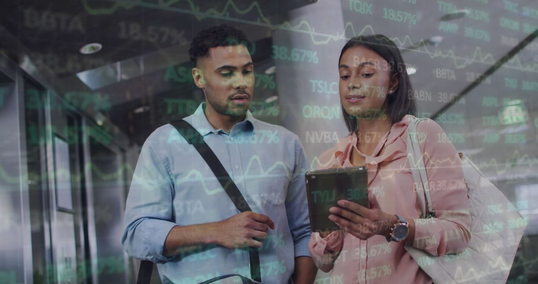 Coworkers Analyzing Financial Data on Tablet in Modern Office