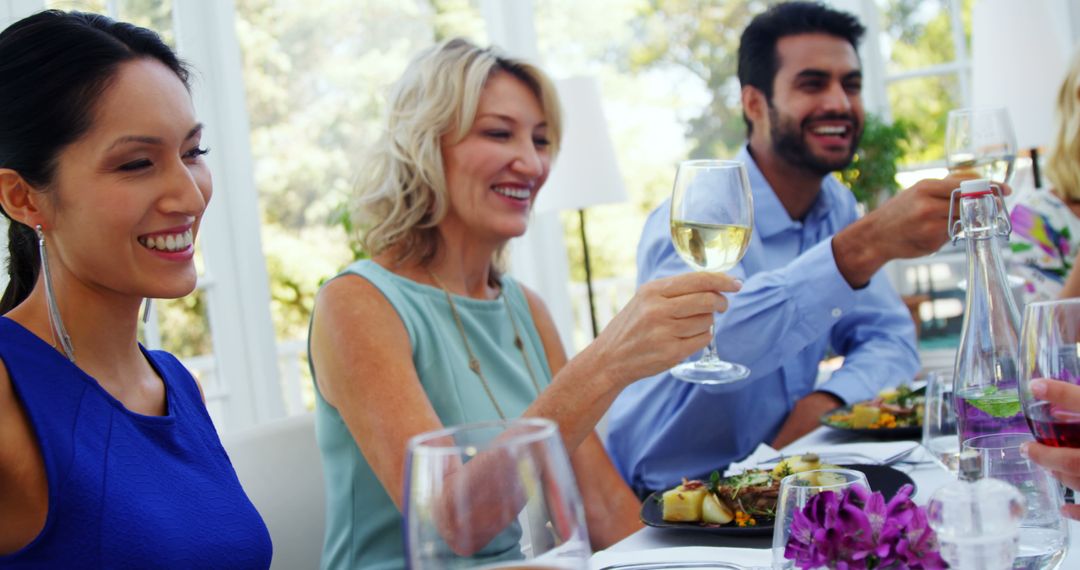 Diverse Group Celebrating with Toast in Outdoor Dining Scene