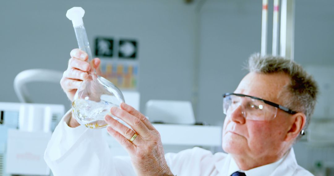 Senior Scientist Examining Chemical Solution in Modern Laboratory - Free Images, Stock Photos and Pictures on Pikwizard.com