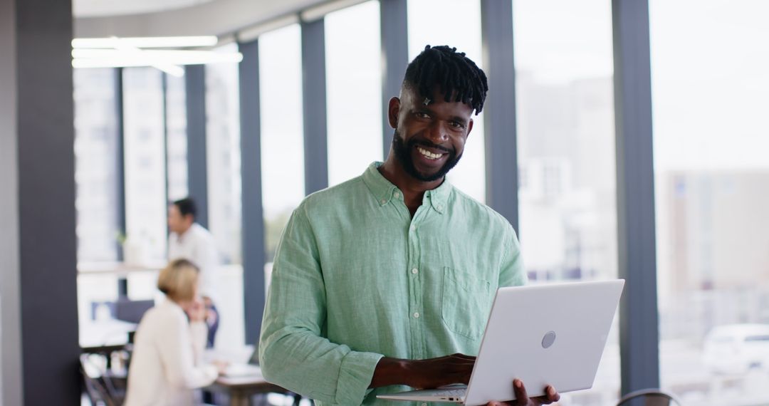 Smiling Professional Collaborating on Laptop in Modern Office