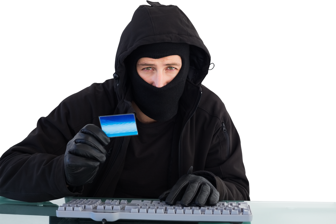 Transparent masked burglar holding credit card using computer - Download Free Stock Images Pikwizard.com