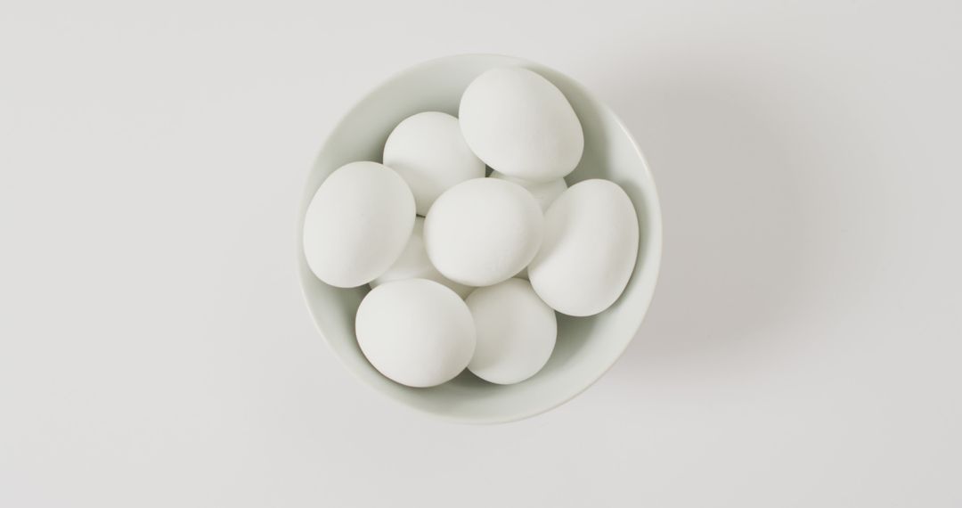 Close up of bowl of white eggs with copy space on white surface - Free Images, Stock Photos and Pictures on Pikwizard.com