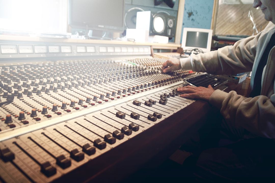 Sound Engineer Operating Professional Audio Mixing Console in Recording Studio - Free Images, Stock Photos and Pictures on Pikwizard.com