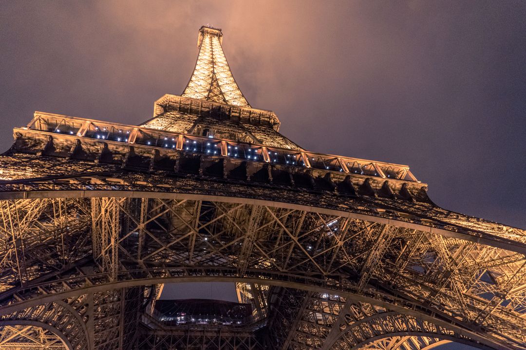 Unique low-angle view of illuminated Eiffel Tower at dusk - Free Images, Stock Photos and Pictures on Pikwizard.com