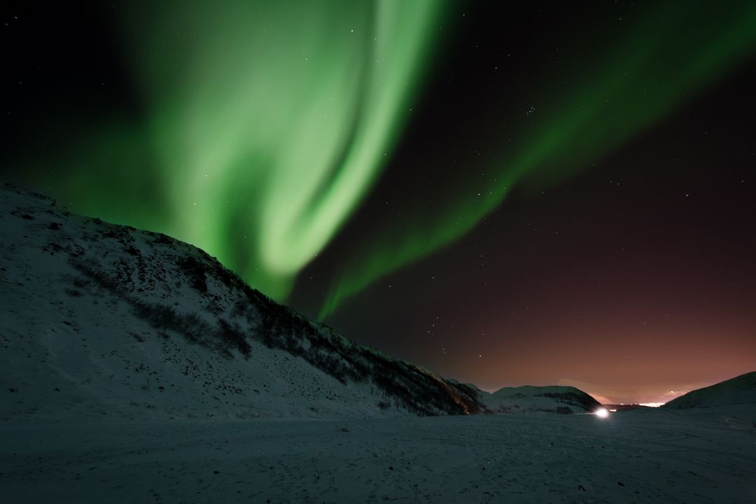 Mesmerizing Northern Lights Over Snowy Mountains - Free Images, Stock Photos and Pictures on Pikwizard.com