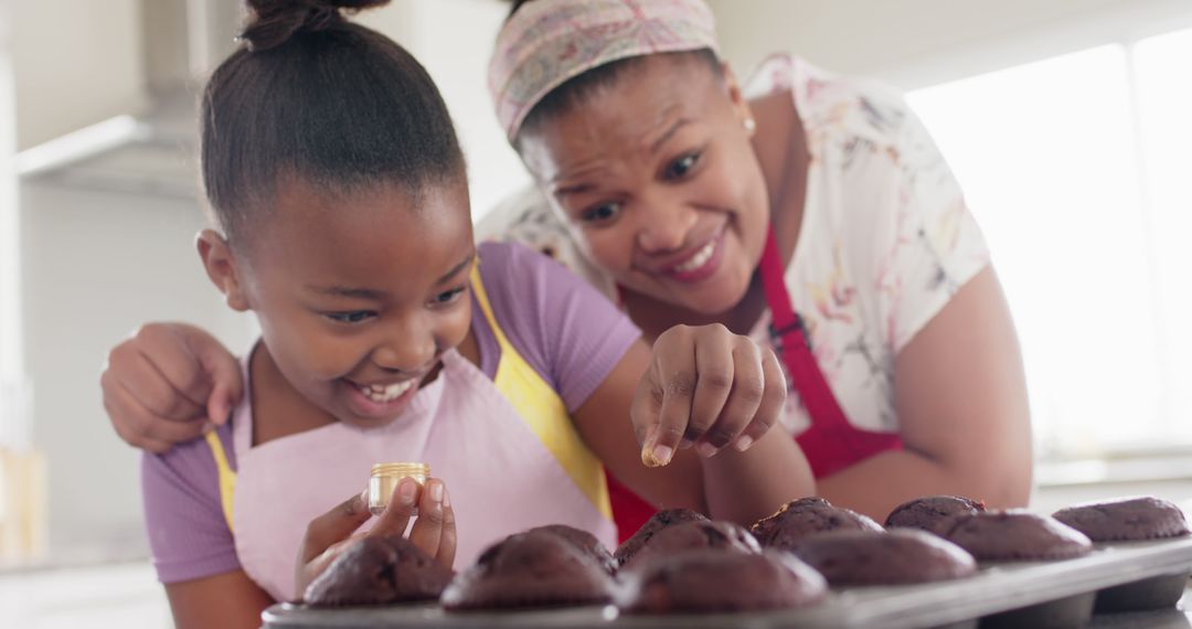 Mother and Daughter Baking Chocolate Muffins Together in Kitchen - Free Images, Stock Photos and Pictures on Pikwizard.com