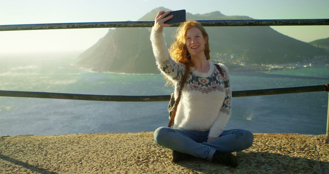 Young Woman Taking Selfie on Mountain Top with Scenic View - Free Images, Stock Photos and Pictures on Pikwizard.com