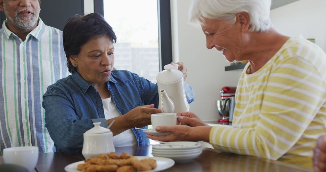 Diverse Group of Senior Friends Enjoying Tea Time Together - Free Images, Stock Photos and Pictures on Pikwizard.com