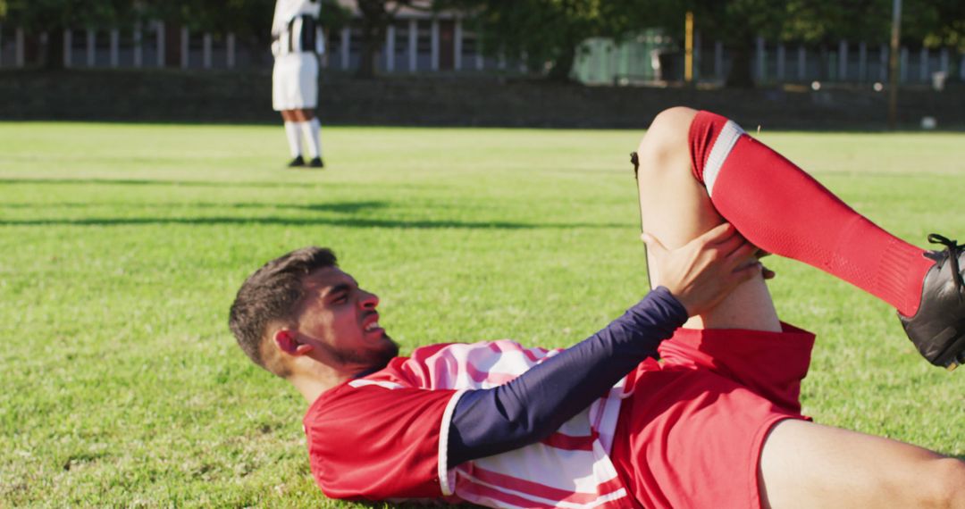 Injured Soccer Player Holding Leg On Field During Match - Free Images, Stock Photos and Pictures on Pikwizard.com